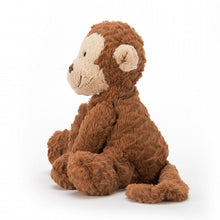A plush toy resembling a smiling monkey with a brown color scheme, made of soft fabric.