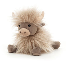 A plush toy resembling a cow with a punky mane and butterscotch fur.