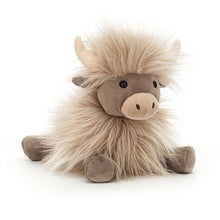A plush toy resembling a cow with a punky mane and butterscotch fur