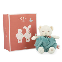 A medium-sized teal plush bear with white accents, presented next to its packaging which features a butterfly motif. The bear has a butterfly decoration on its right hand and embroidered details on its feet.