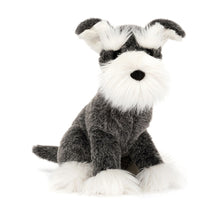 A plush toy resembling a Schnauzer dog with grey and white fur, big ears, and a soft expression.