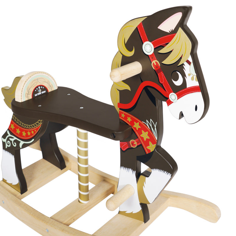 A traditional wooden rocking horse with brown and white color scheme, featuring hand and foot grips, and decorative carousel horse and reins artwork.