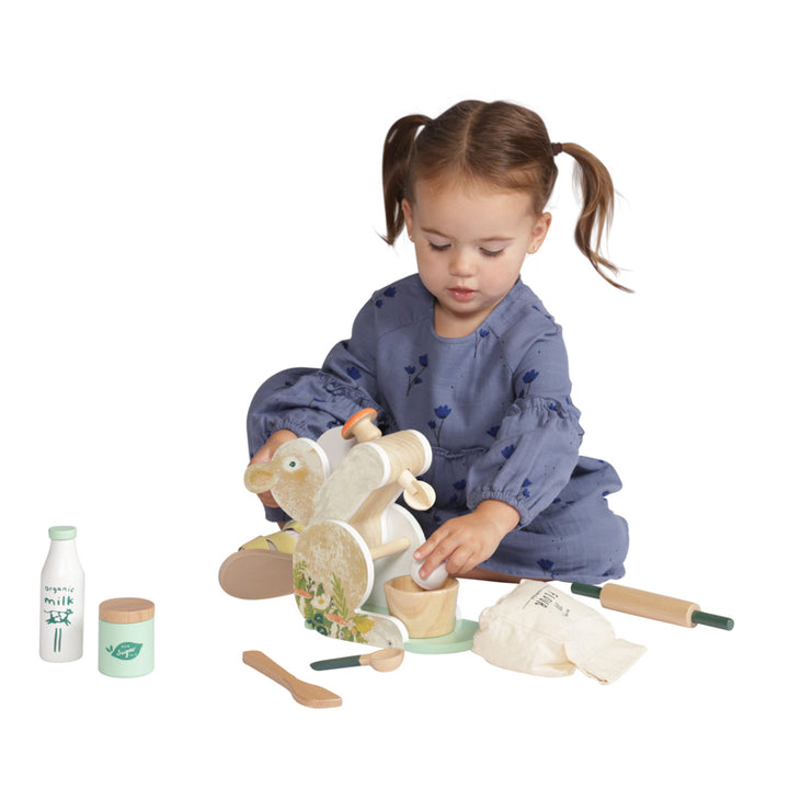 Young girl playing with Bunny Hop wooden Mixer play set