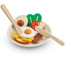 Wooden toy breakfast set including a plate, cutlery, and various play food items like eggs, bacon, and vegetables served on the plate.