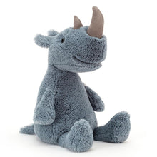 A plush toy resembling a gray rhinoceros with a happy expression, sitting upright.