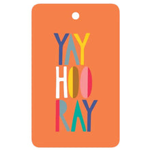 A gift tag with the text 'YAY HOORAY!' in a colorful, bold font, attached to a natural hemp cord.