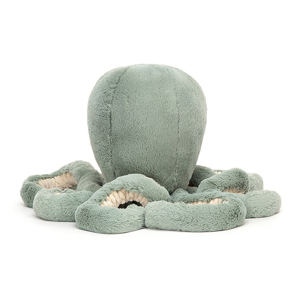 A large sea moss green plush resembling an octopus toy with  long curly tentacle arms.