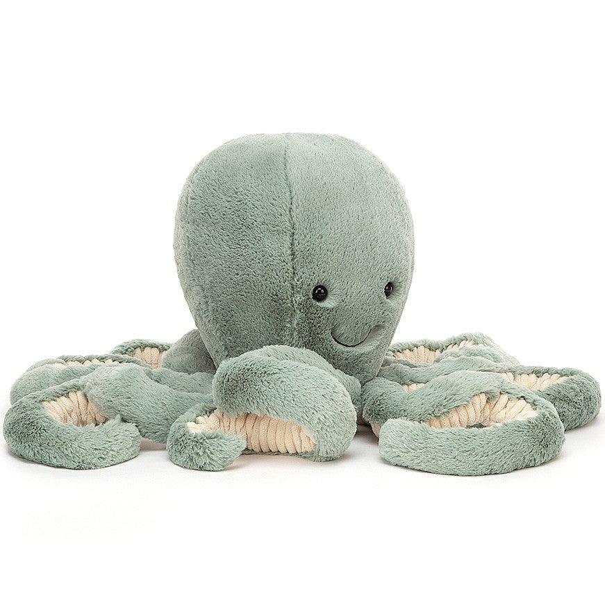 A large sea moss green plush octopus toy with bright, glossy eyes and long curly tentacle arms.