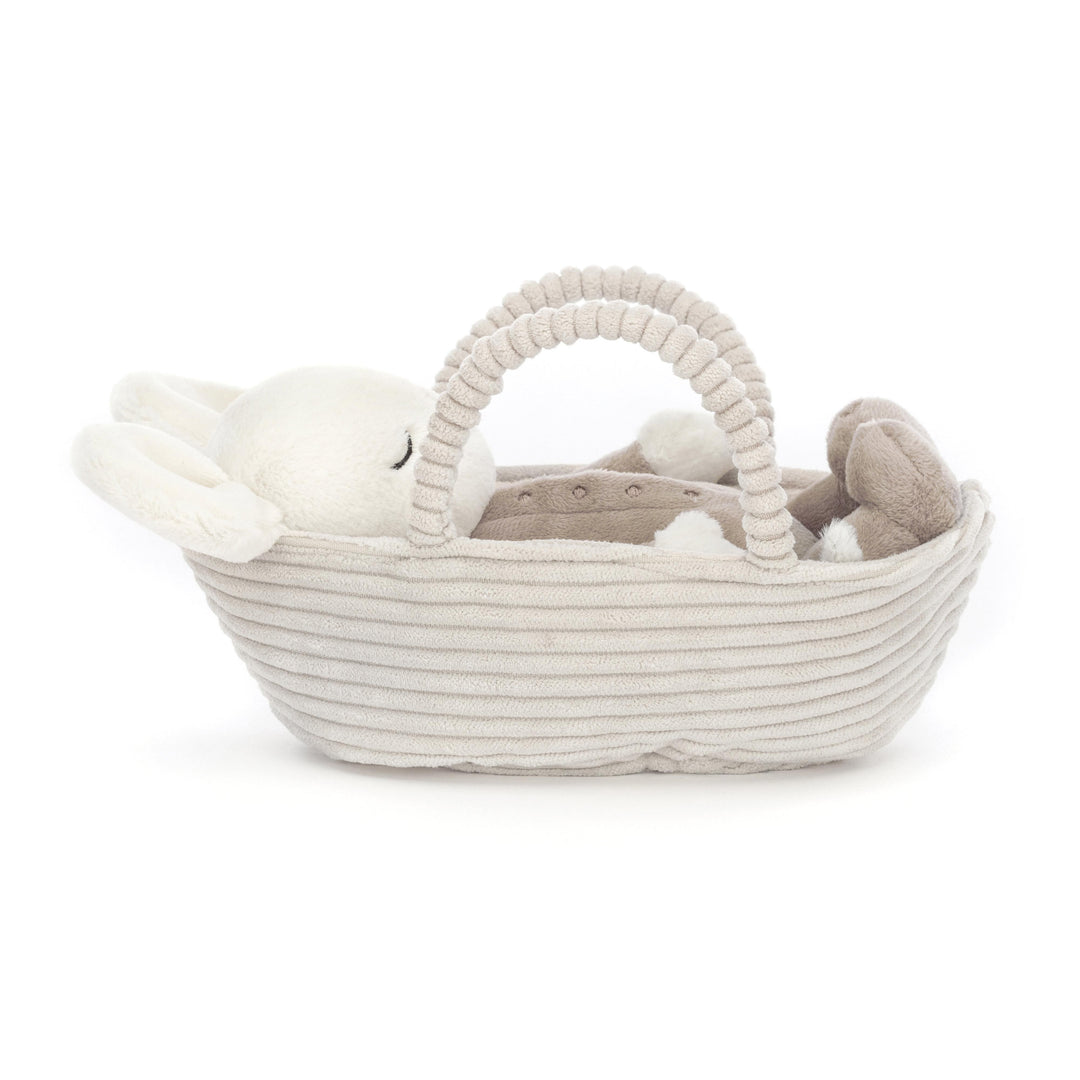 Jellycat cream coloured baby mouse with large cream ears and sleeping face. Wearing a coffee colour jumpsuit, laying in a cream cord fabric carry basket - Send A Toy